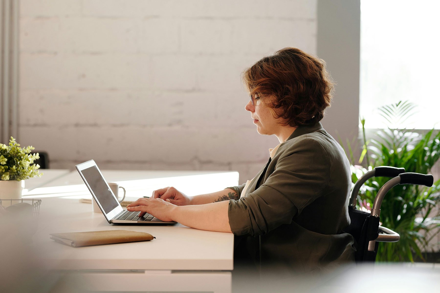woman-in-a-wheelchair-working-on-laptop-at-home