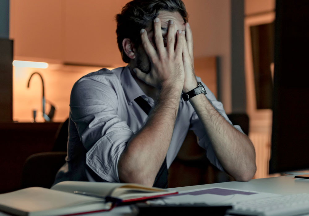an office team member struggling to stay on top of workplace stress