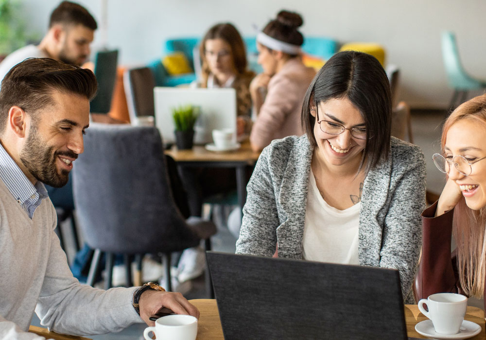 small group of office workers laughing and smiling