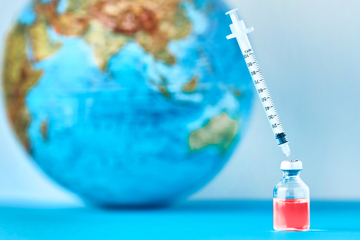 Medical syringe against a globe