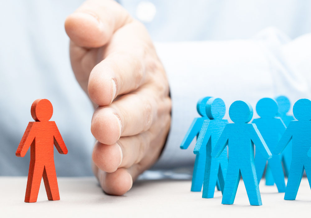 photo showing a cutout paper figure being separated and treated differently to others